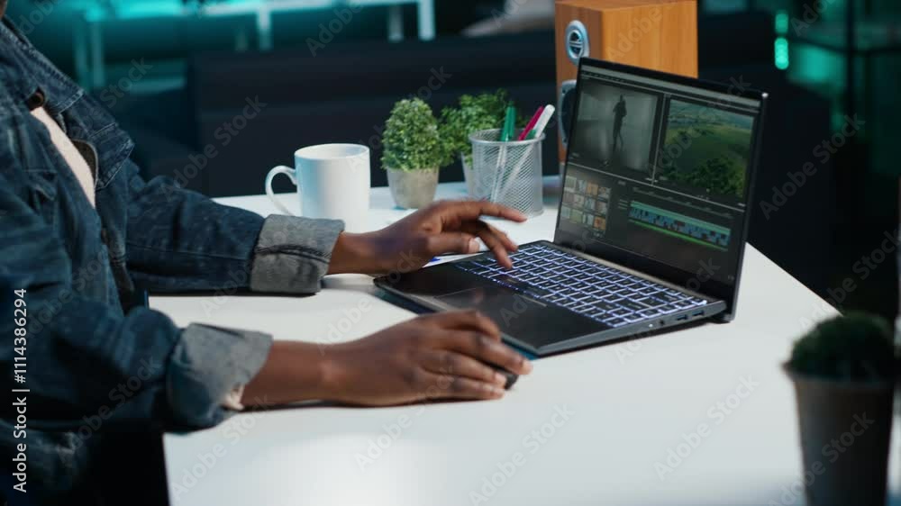 Video editor selecting key frames to use while doing video montage, using specialized software applications. Freelancer using editing tools on computer to cut movie project footage in office, camera A Video editor selecting key frames to use while doing video montage, using specialized software applications. Freelancer using editing tools on computer to cut movie project footage in office, camera A