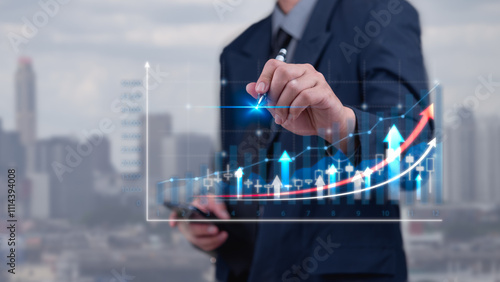 Fotografie Businessman hand touching graph and arrow chart