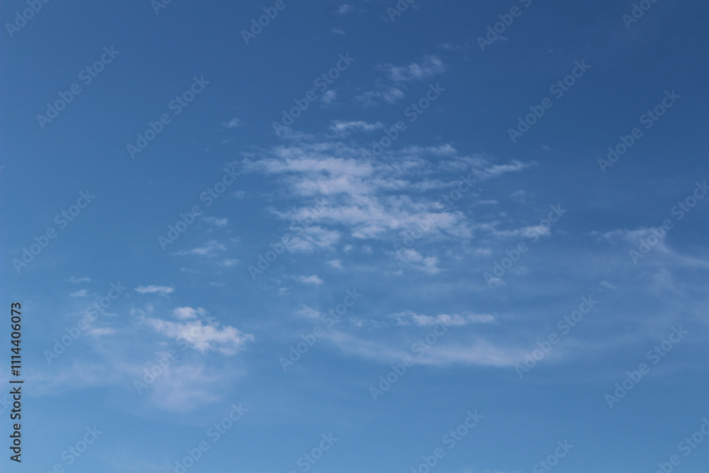 Obraz premium blue sky background with blurred light white clouds