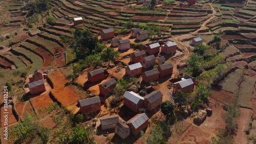 Aerial view of a village nestled in the heart of Madagascar's highlands, showcasing the traditional architecture and the surrounding agricultural landscape photo