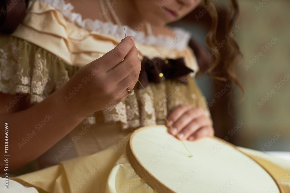 Side view detail shot of young lady guiding thread through fabric doing intricate embroidery in vintage setting, copy space Side view detail shot of young lady guiding thread through fabric doing intricate embroidery in vintage setting, copy space