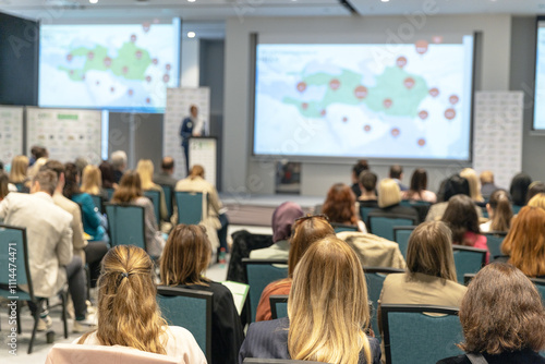 Wallpaper Mural Business conference and presentation or international political event in a modern conference hall with large screens displaying data visuals Torontodigital.ca
