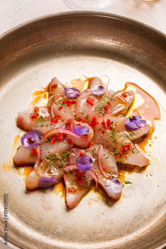 marinated swordfish carpaccio with seasoning and flowers