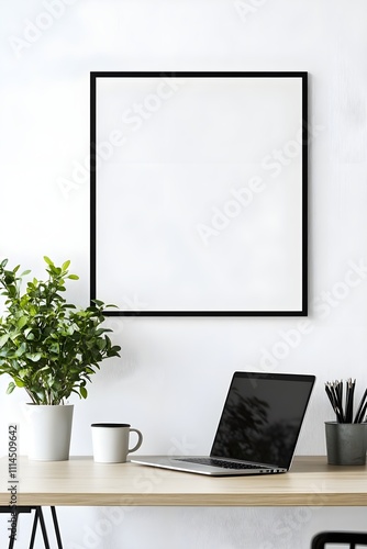 Wallpaper Mural A minimalist workspace with a black frame on a clean white wall above a sleek wooden desk, featuring a laptop, a coffee cup, and a potted plant. Torontodigital.ca