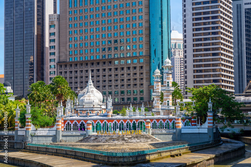 High rise buildings with Masjid Jamek Mosque in Kuala Lumpur, Malaysia photo