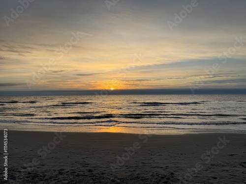 Sunrise peaking over the waves