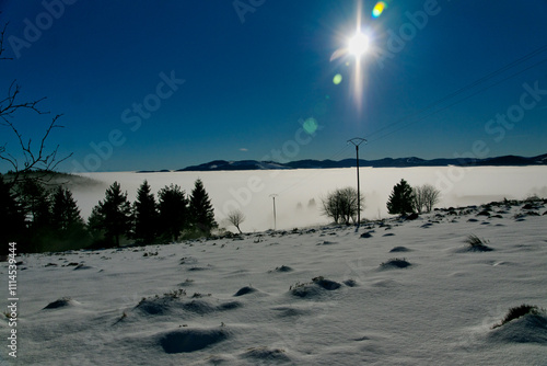 Blick in ein wolkenverhangenes Vogesental im Winter photo