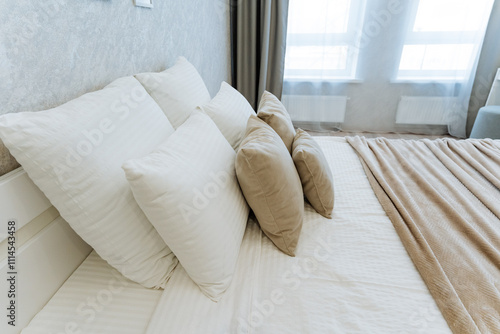 Obraz na plátně A cozy and beautifully decorated bedroom showcases a neatly made bed dressed in