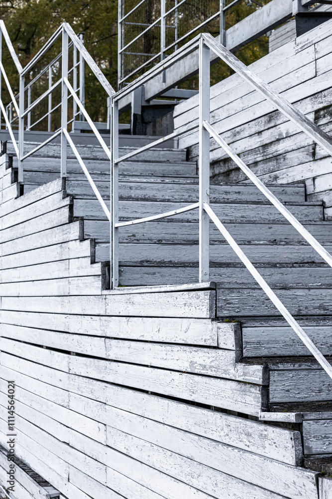Fototapeta premium fragment of an old wooden staircase, without people. wooden steps of an old staircase. wooden staircase with railings. Vertical photo