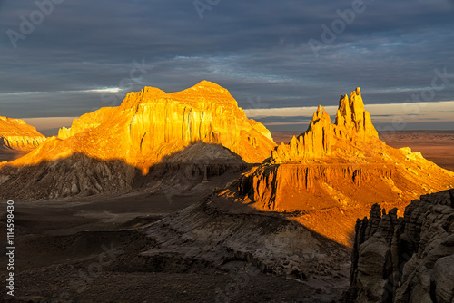 Kazakhstan, Mangistau, Mangyshlak, Airakty. Beautiful jagged mountain with numerous peaks at dawn under a crimson sky. Drone view