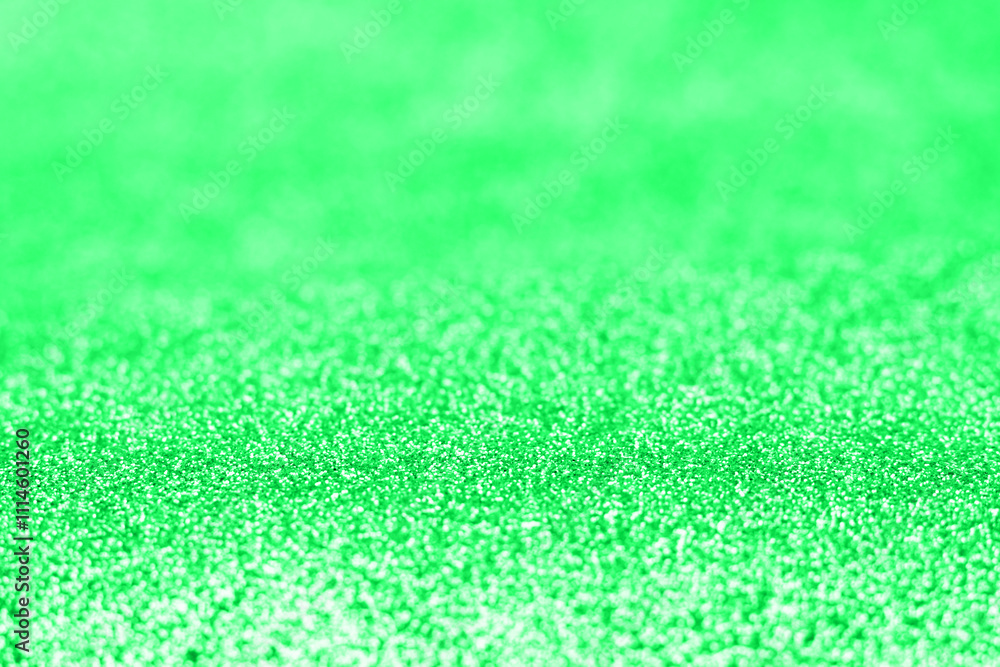 Fototapeta premium Abstract green glitter blurred holiday texture.