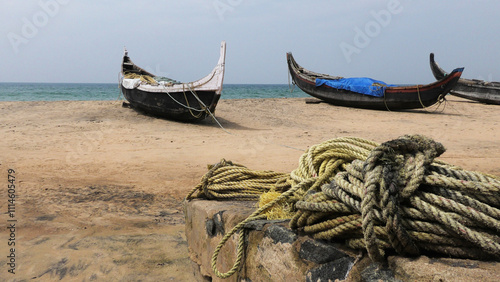 Fishing boats moored on the beach at Kovalam, Thiruvananthapuram, Kerala, India photo