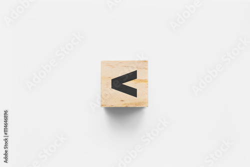 < (Less Than) wooden cube on white background photo