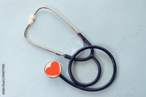 Red stethoscope and phonendoscope with chrome chestpiece carries out survey. Concept for protection, treatment and prevention of heart from diseases of cardiovascular system photo