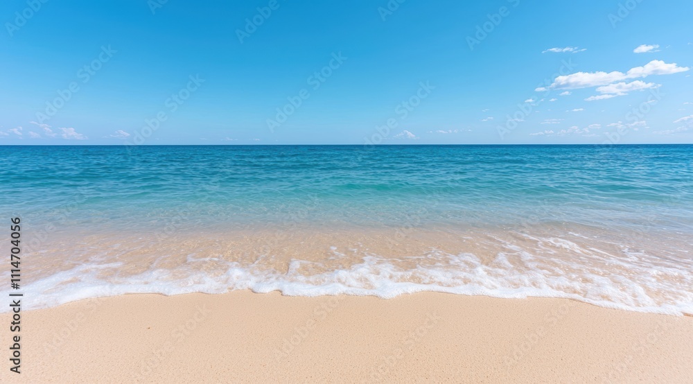 Fototapeta premium Serene beach scene with clear blue sky and turquoise waters