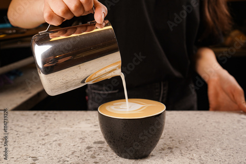 Close-up of the process of brewing cappuccino coffee with thick milk foam from the cappuccinatore. photo