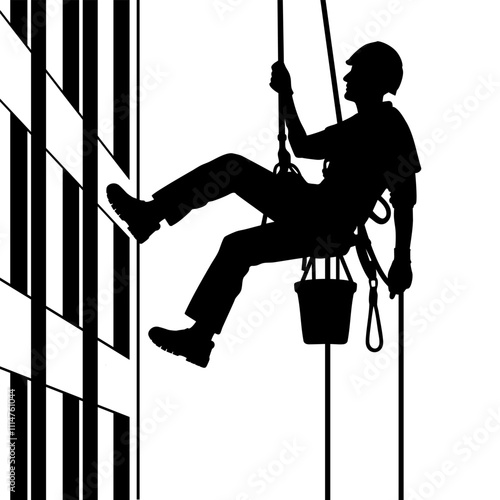 Silhouette of a rope access technician working on a building facade suspended by ropes