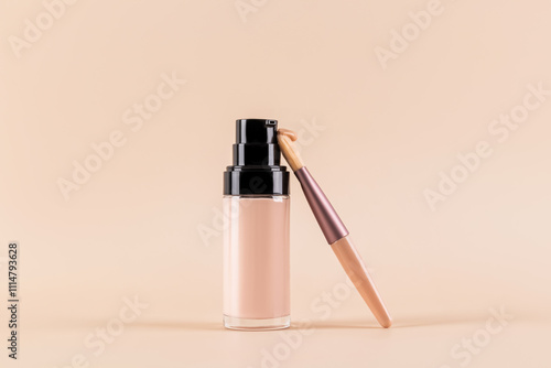 Foundation Bottle and Brush on Minimal Beige Background photo