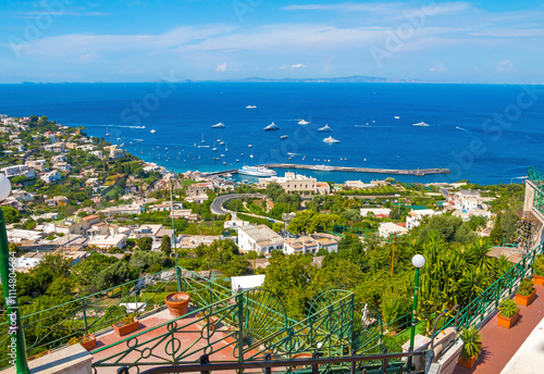 Obraz na płótnie view of Capri, including the Gardens of Augustus, with vibrant flowers, lush greenery, and panoramic vistas of the coastline and iconic Faraglioni rocks. w salonie