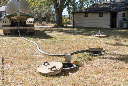 Septic tank maintenance. Vacuum truck pumping septic tank