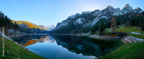 Beautiful Gosausee lake landscape with Dachstein mountains, forest, clouds and reflections in the water in Austrian Alps. Salzkammergut region