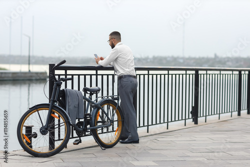 Young businessman with mobi...