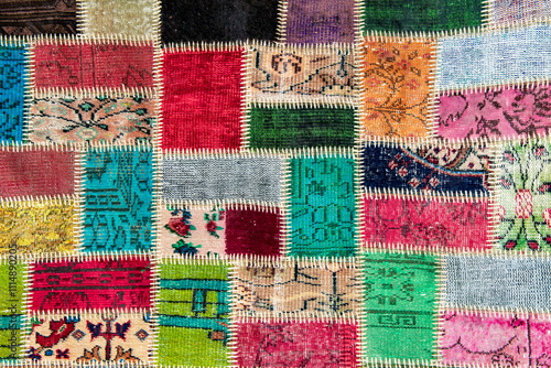 A colorful patchwork quilt made of vibrant fabric pieces with intricate patterns, sewn together with visible stitching, 