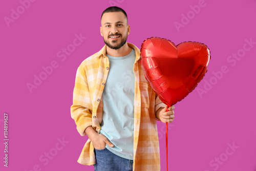 Smiling young man holding r...
