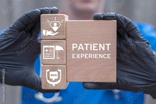 Doctor holding wooden blocks sees inscription: PATIENT EXPERIENCE. Health care concept of patient experience.