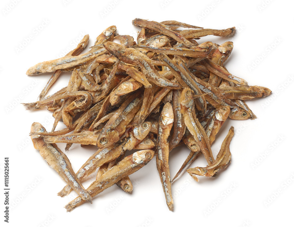 Obraz premium pile of dried sprats or anchovies isolated white background, preserved small oily fish with strong salty flavor 