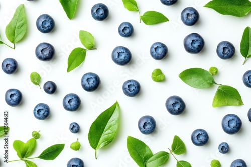 Vibrant arrangement of fresh blueberries with green leaves on white background