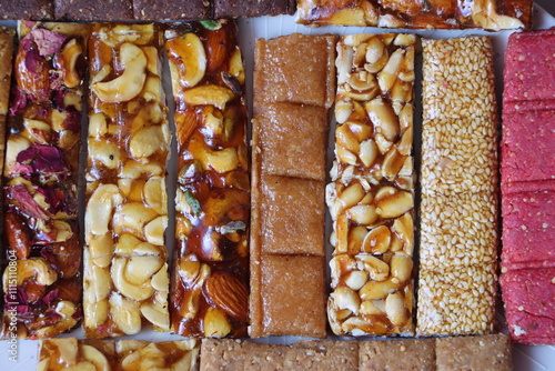 Chikki, Indian sweet (brittle) made from nuts and jaggery orsugar, groundnut (peanut) chikki, dry fruits, sesamum, fruit crush etc. photo