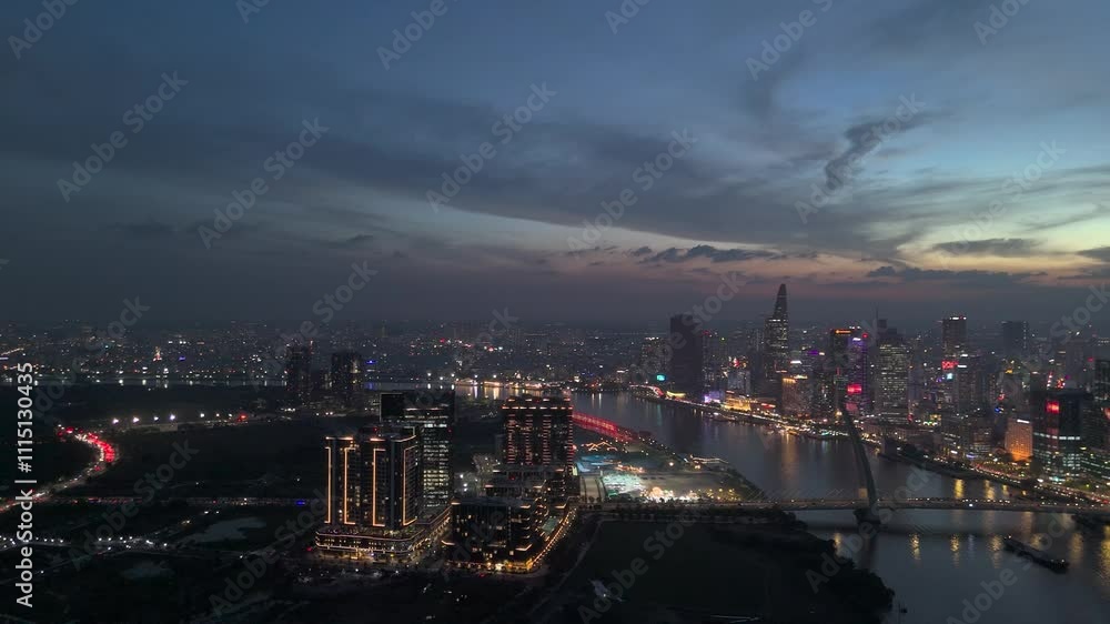 Ho Chi Minh City, Vietnam, aerial evening sunset panorama of city skyline and Saigon River with colorful sky. Ho Chi Minh City, Vietnam, aerial evening sunset panorama of city skyline and Saigon River with colorful sky.