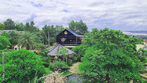 Photo of a restaurant and coffee shop in a park near the Mekong River bank, Mukdahan Province, Thailand.