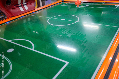 A close-up view of an air hockey table. The green playing surface shows the marked field ready for a game. Air Hockey Table Game. photo