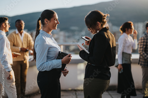 A diverse group of business colleagues brainstorms on a high tower balcony during sunset. The setting encourages creativity and collaboration in a multicultural environment. photo