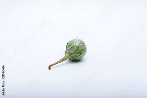 Healthy green round mini eggplant vegetable photographed with white base and background