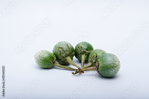 Healthy green round mini eggplant vegetable photographed with white base and background
