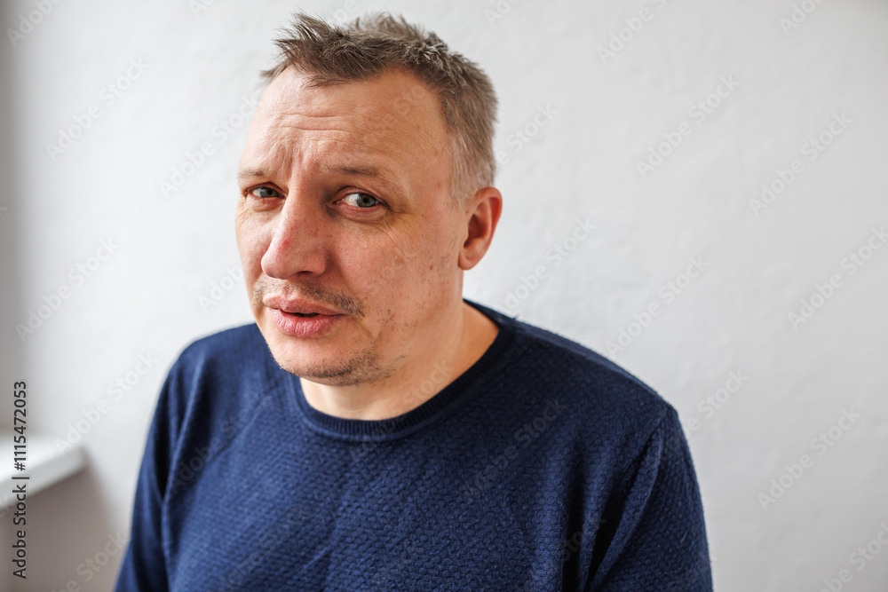 Fototapeta premium distorted face of a sad and sorrowful very upset man