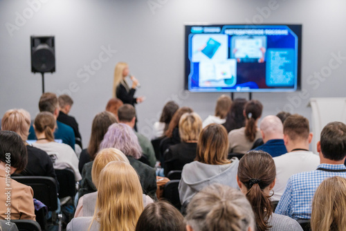 Wallpaper Mural Diverse audience attentively listening to a speaker at a business conference. Presentation displayed on a big screen in a modern meeting room setting. Torontodigital.ca