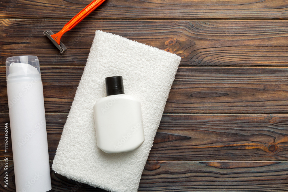 Naklejka premium shaving man set. shaving machine, towel, lotion and shaving foam on colored background. Men bath Accessories top view