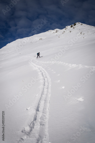 Ski touring in the french alps. Skier in the fresh snow.