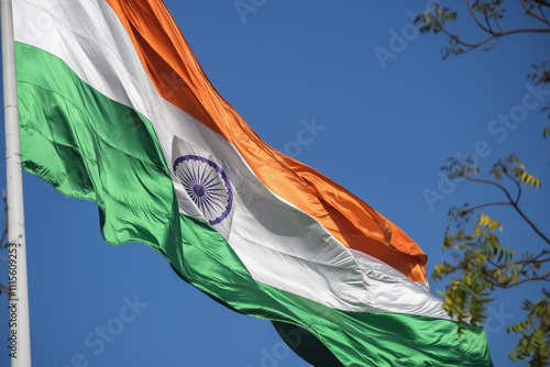 India flag flying high at Connaught Place with pride in blue sky, India flag fluttering, Indian Flag on Independence Day and Republic Day of India, tilt up shot, Waving Indian flag, Har Ghar Tiranga