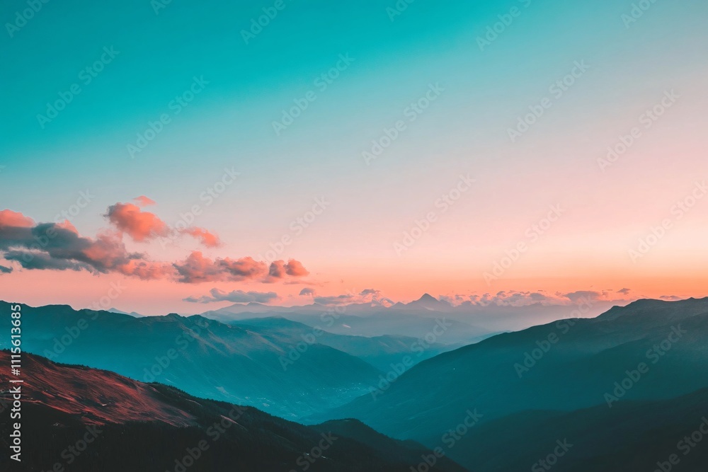 Obraz premium Clear sky over a sprawling mountain range, sunset glow with three-quarters sky in frame, orange and pink colors fading to blue at dusk 1