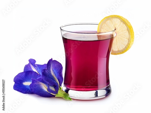 Glass cup of organic purple butterfly pea flower tea (blue pea, bluebellvine, cordofan pea, clitoria ternatea) with lemon isolated on white background.