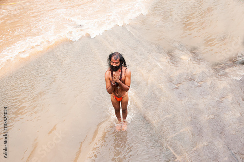 A Sadhu offering prayer in Godavari river during the Simhastha Kumbh Mela, India. photo