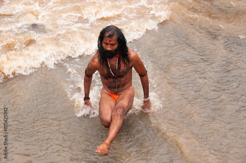 A Sadhu offering prayer in Godavari river during the Simhastha Kumbh Mela, India. photo