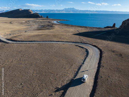 Aerial view of  offroad car running on corrugated road in the remote part of Tibet, China photo