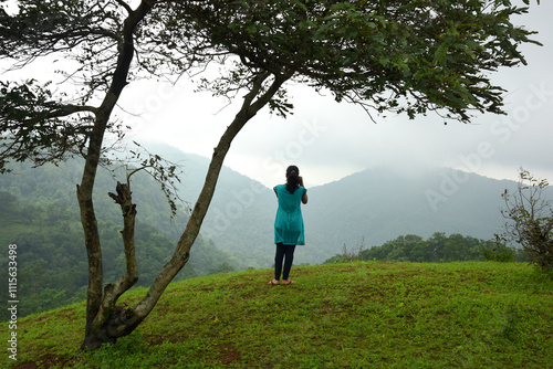 Beautiful young woman in nature with camera