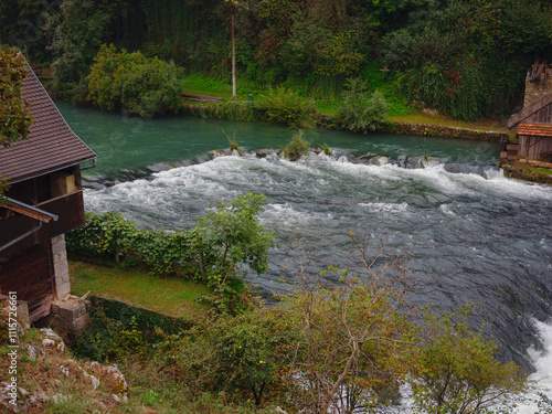 Travel to Slunj in Croatia. Breathtaking view on forest near Korana river, beautiful countryside landscape, early autumn, with hints of green transitioning to yellow. seasonal change photo